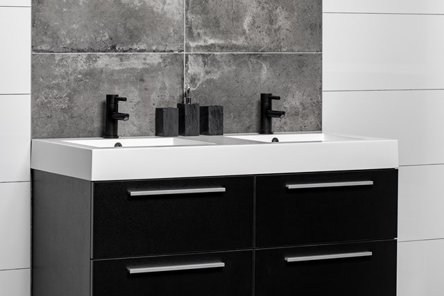 Black bathroom furniture set with double basin in white, sleek design, featuring metal handles and modern black taps.