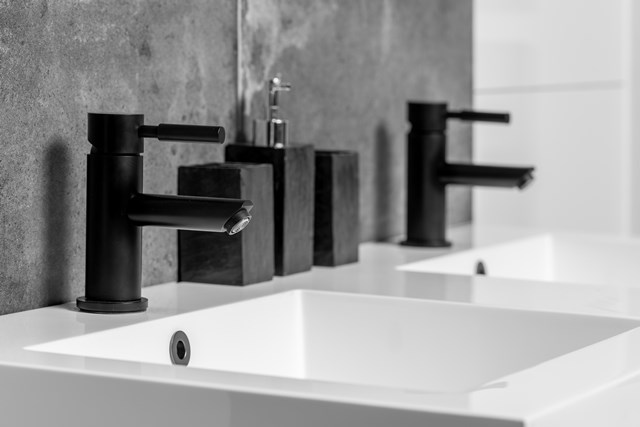 Matte black basin taps with modern shape on double basin, perfect for a stylish and contemporary bathroom design.