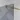 Shower wall with frosted black glass and gold-coloured stabilising bar, modern design for a stylish bathroom.
