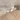 White siphon with plastic pipes under a washbasin, ideal for modern bathroom decor, mounted on wooden surface.
