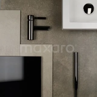 Black round basin tap made of stainless steel next to a modern white basin on a grey bathroom tile.