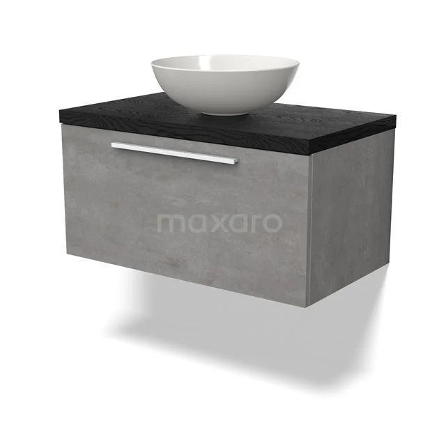 Betonnen wastafelmeubel met mat zwarte bovenplaat en ronde waskom, modern badkamerdesign met opberglade.