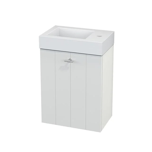 White bathroom unit with basin, compact design, vertical wooden panels and metal handle, ideal for small bathrooms.
