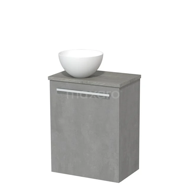 Compacte grijze badkamerkast met matte afwerking, bovenop een witte keramische waskom, modern design voor kleine badkamers.