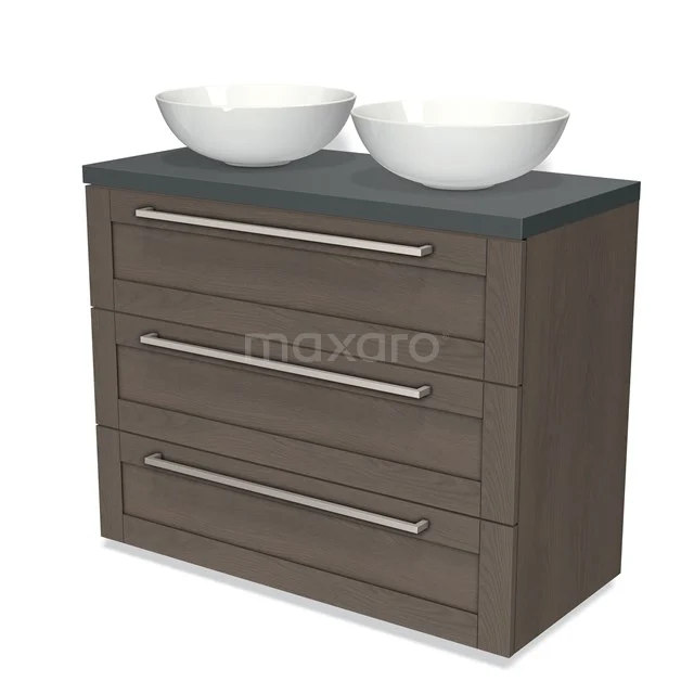 Wooden bathroom unit with dark grey worktop, double white drawers and three drawers with silver handles.