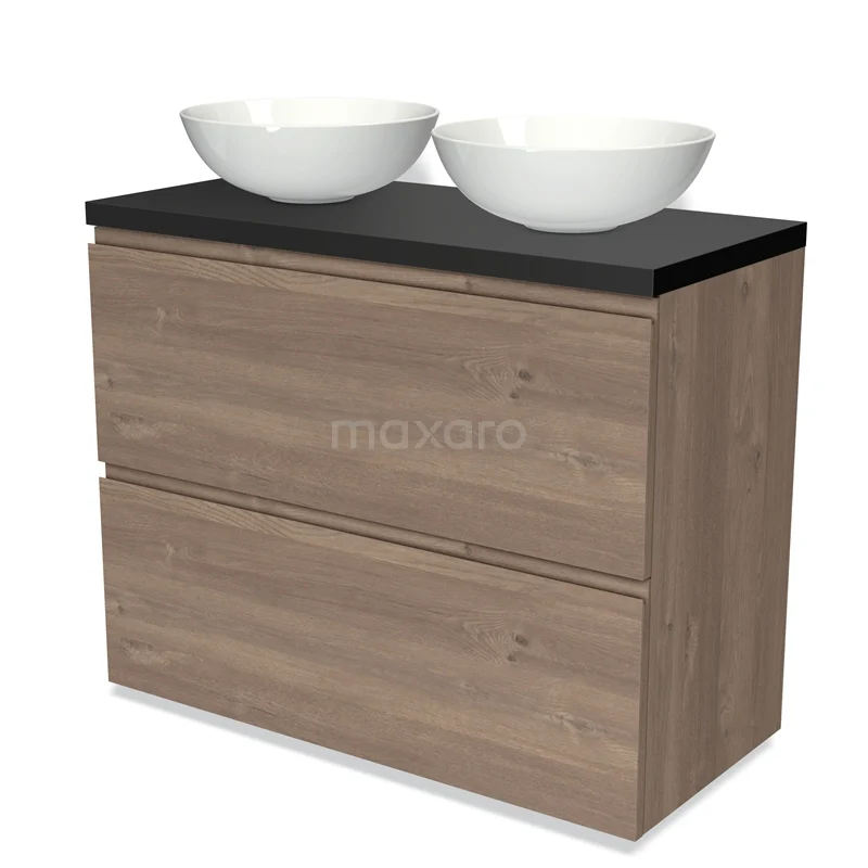 Badmöbel für Waschtischunterschrank mit Konsole 100cm Modulo Plato mittelbraune Eiche 2 hohe Schubladen grifflos Matt Schwarz Platte BMK13-00953 Hölzernes Badezimmermöbel mit dunkler Platte, zwei weißen Aufsatzwaschbecken und Schubladenlagerung; stilvoll und praktisch für moderne Bäder.